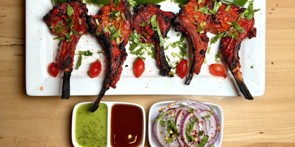 A plate of Tandoori Chicken skewers with vibrant colors and juicy, tender meat, cooked in a traditional clay oven.