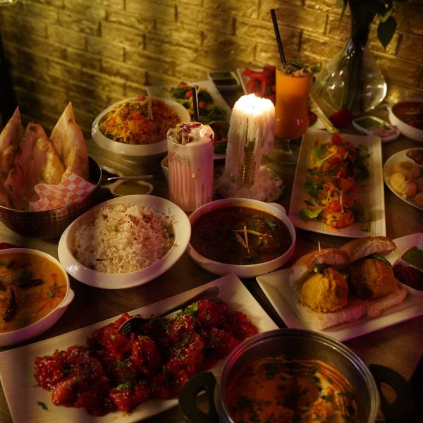 A vibrant display of Indian dishes at Leela Indian Food Bar, showcasing diverse regional flavors and culinary traditions.